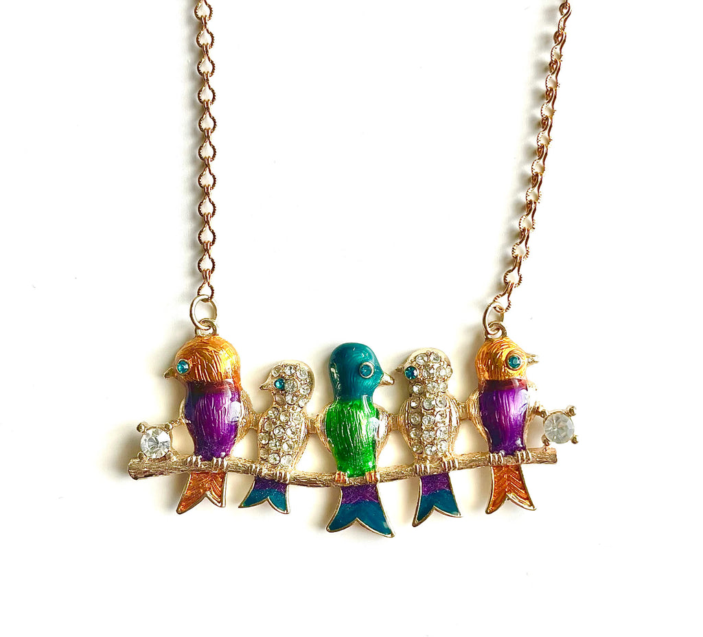 Colorful bird-shaped necklace on a white background
