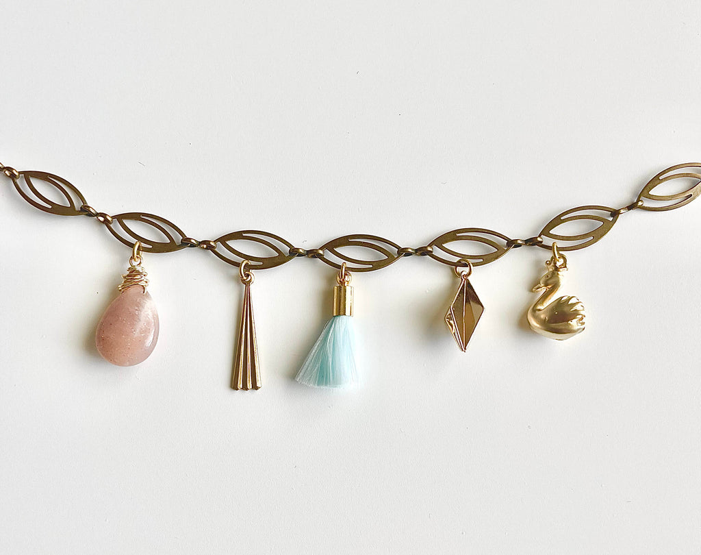 Necklace with various charms on a white background