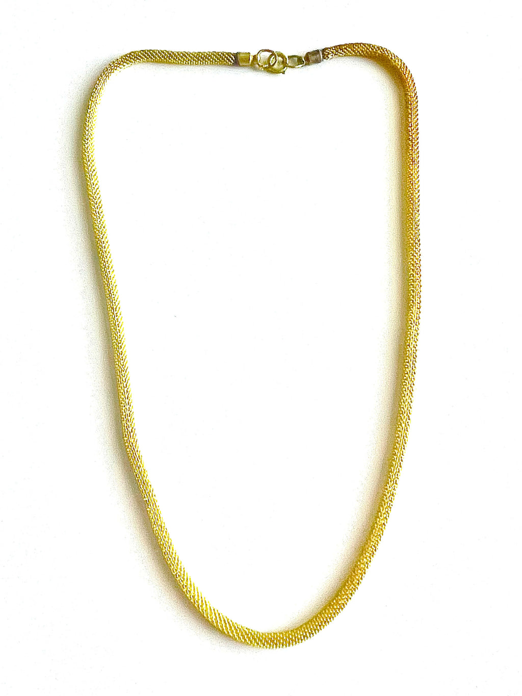 Yellow brass mesh necklace on a white background