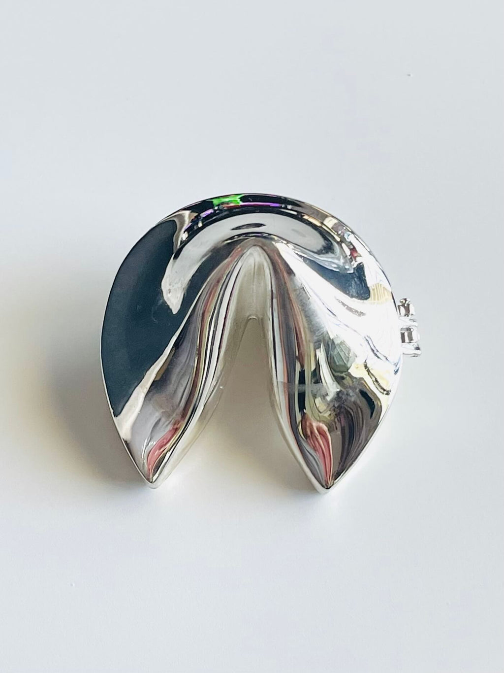 Silver fortune cookie trinket box on white background