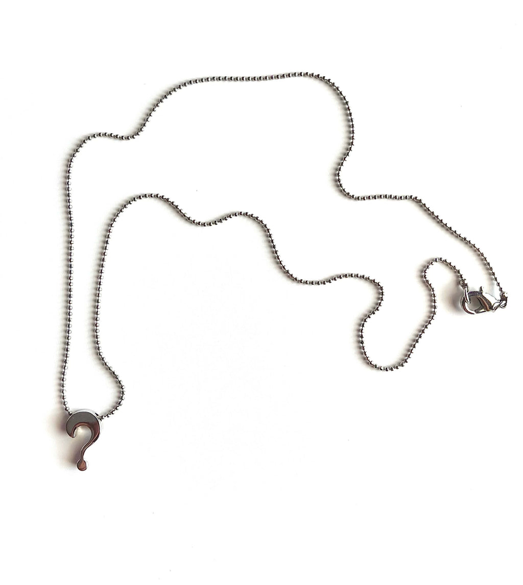 Silver question mark charm on silver ball chain necklace with white background
